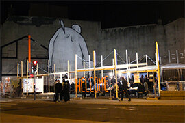 The giant and the helping hand at the street corner